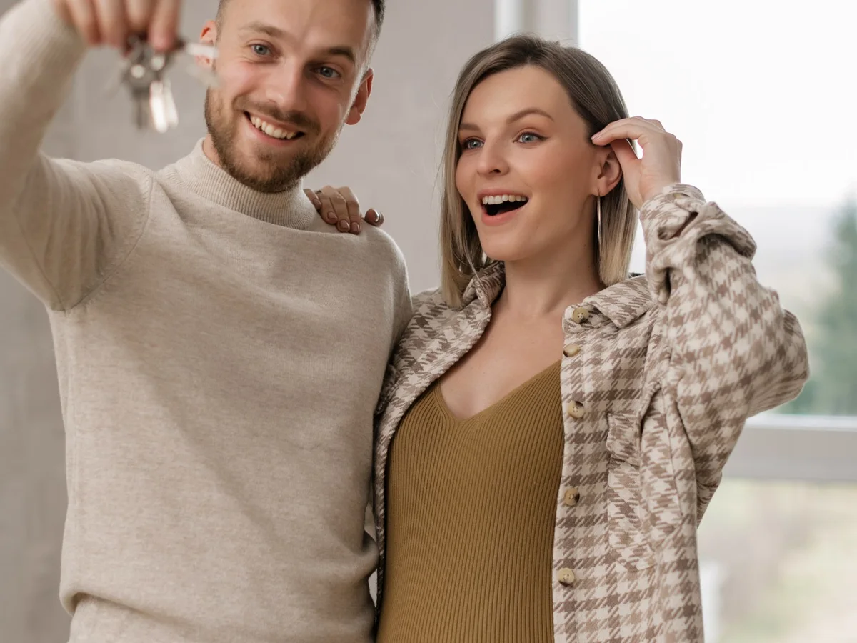 A happy couple celebrating the keys to their new home.