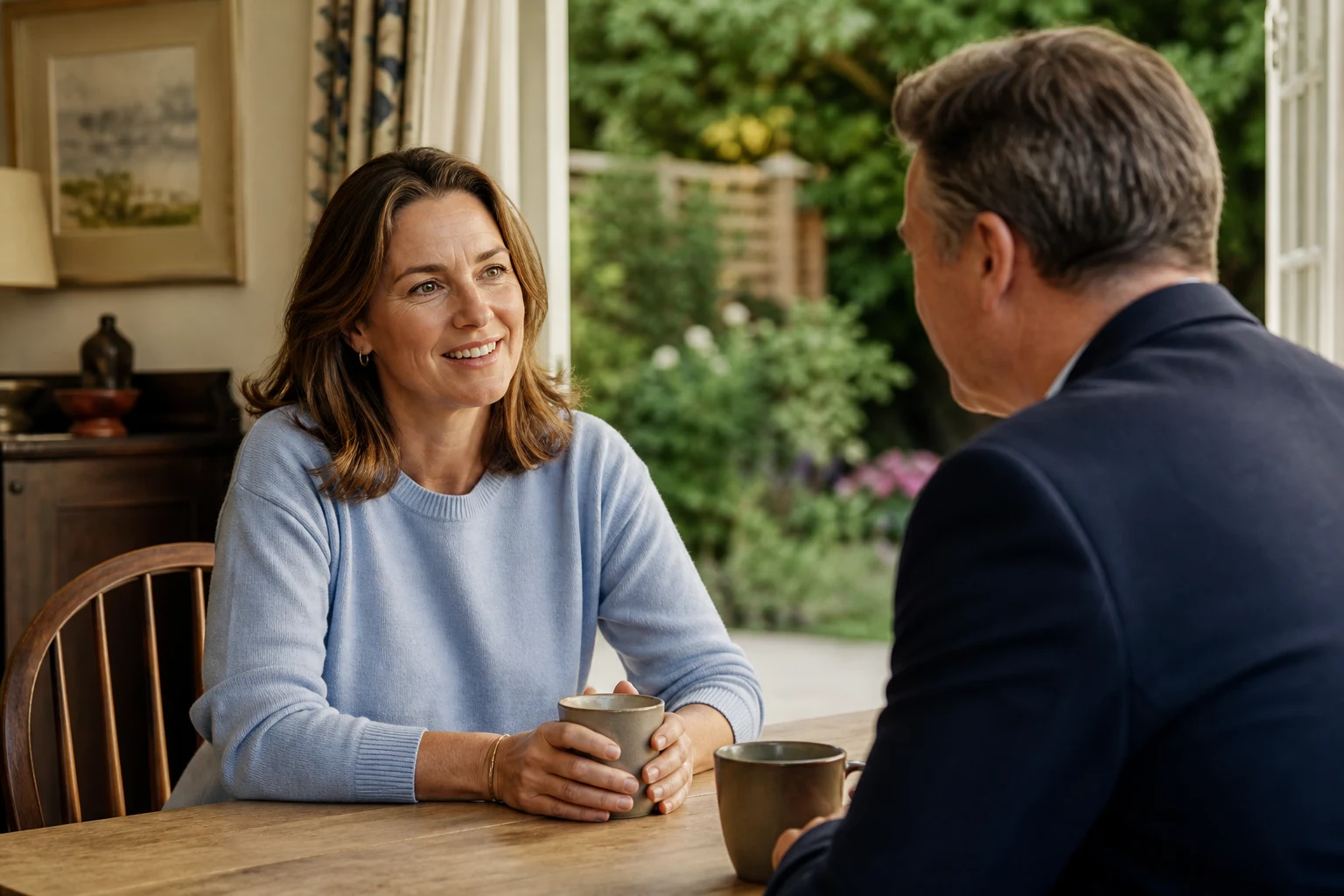 A homeowner having a relaxed conversation with a property adviser at home.